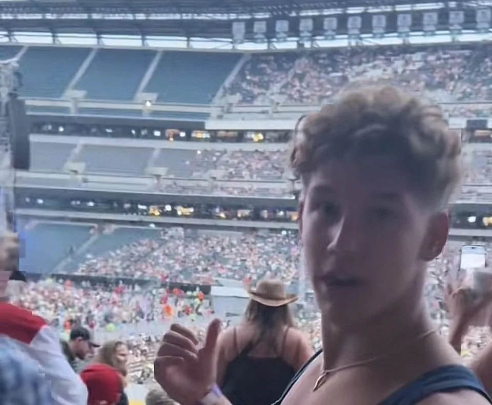 Jake at the Zach Bryan concert with the packed stadium behind him