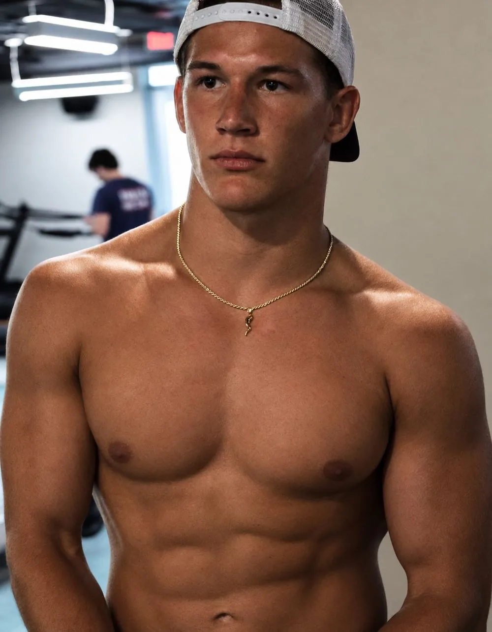 Portrait of Jake Dailey in the gym wearing a backwards white cap